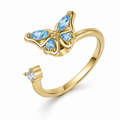Bague anti-stress rotative Papillon Luisant dorée, papillon aux ailes de pierres bleu ciel taille marquise